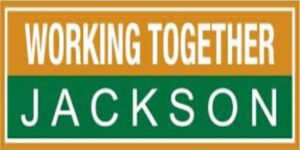 A green and white sign that says working together jackson.
